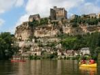 Beautiful landscape with tourists kayaking on river Dordogne and Ch&#xc3;&#xa2;teau de Beynac in the background as seen in Beynac-et-Cazenac, Southern France